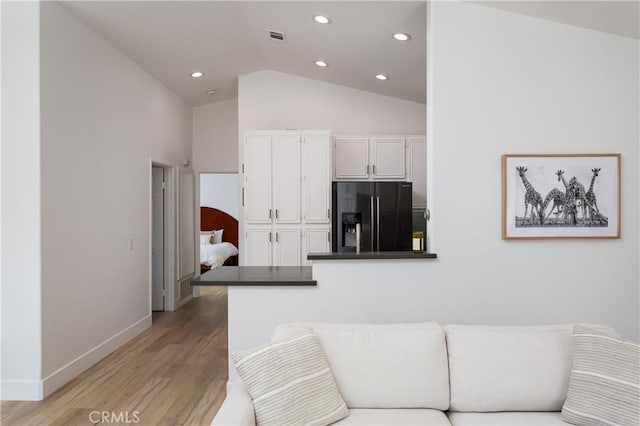 living room with lofted ceiling and light hardwood / wood-style floors