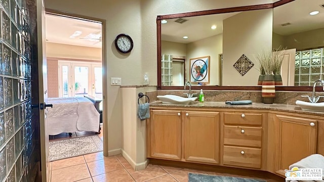 bathroom featuring french doors, tile patterned floors, and vanity