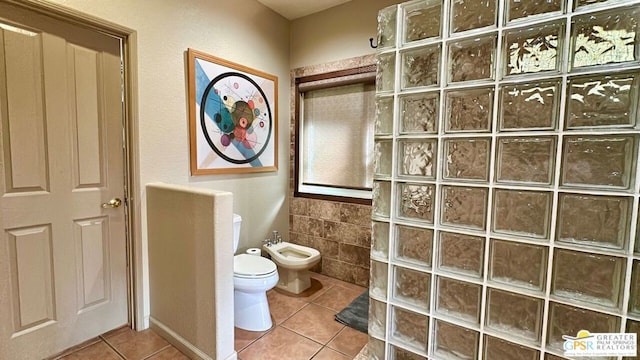 bathroom featuring walk in shower, a bidet, toilet, and tile patterned flooring