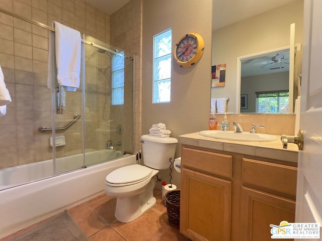 full bathroom featuring plenty of natural light, tile patterned floors, toilet, and combined bath / shower with glass door