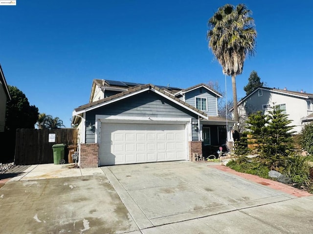 view of front of property featuring a garage and solar panels