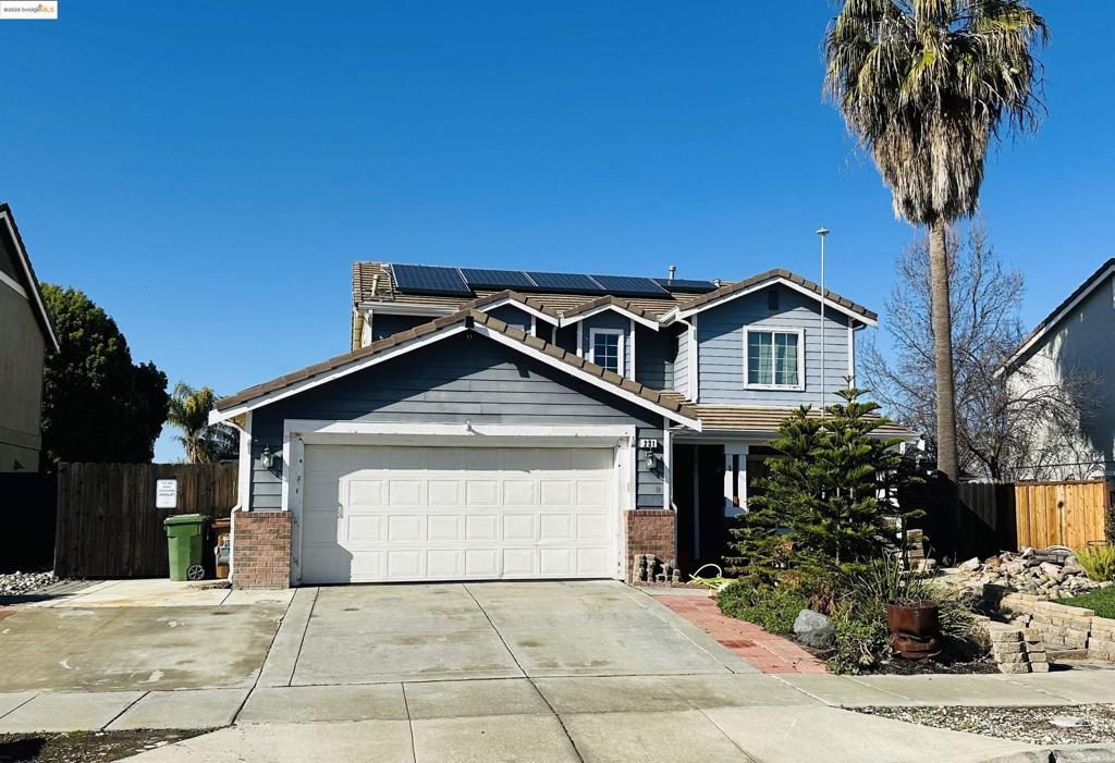 craftsman-style home with a garage and solar panels