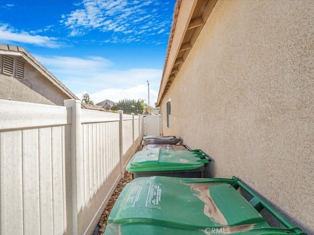 exterior space featuring fence and stucco siding