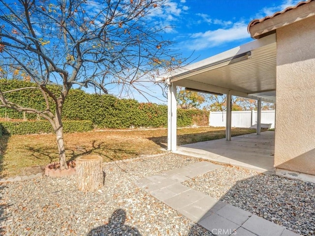 view of yard featuring a patio area and fence