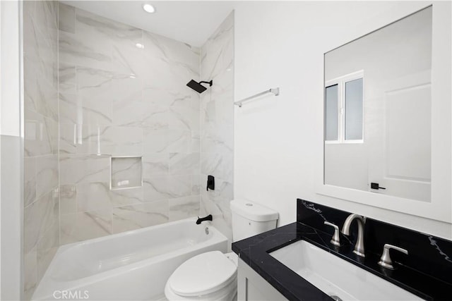 full bathroom with tiled shower / bath, vanity, and toilet