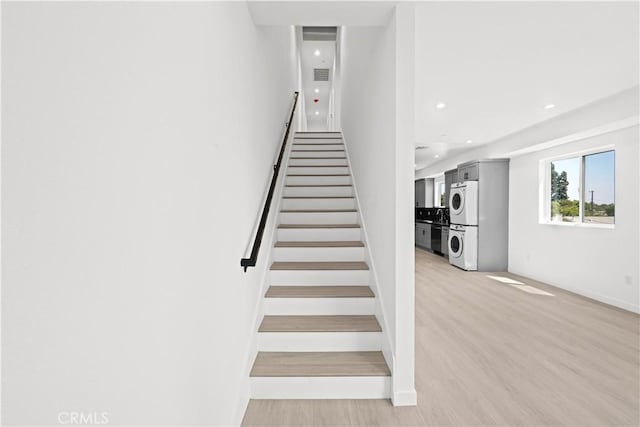 stairs featuring wood-type flooring