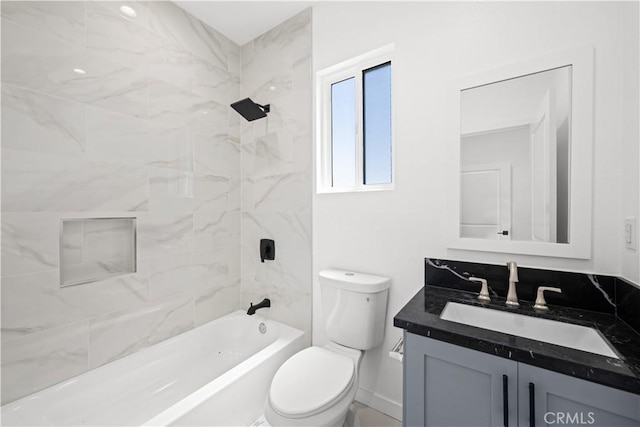 full bathroom with vanity, toilet, and tiled shower / bath