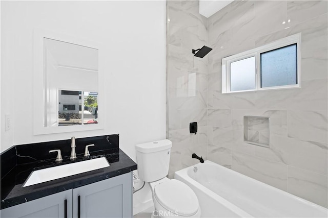 full bathroom with vanity, toilet, tiled shower / bath combo, and plenty of natural light