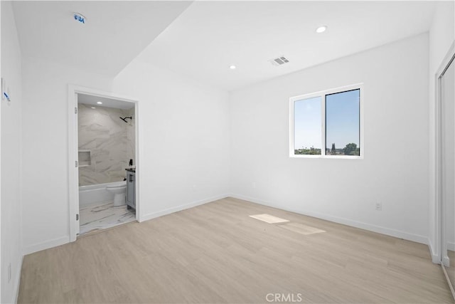 spare room featuring light hardwood / wood-style flooring