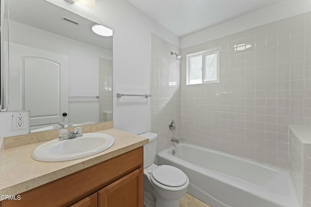 bathroom with toilet,  shower combination, vanity, and visible vents