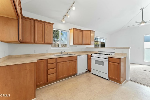 kitchen featuring white appliances, light countertops, a sink, and brown cabinetry