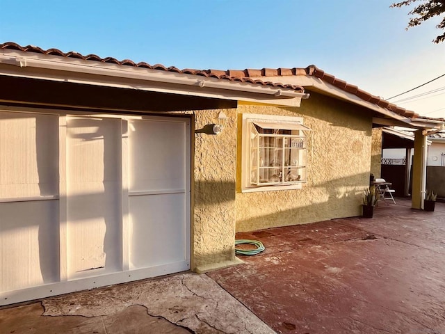 view of property exterior with a patio area