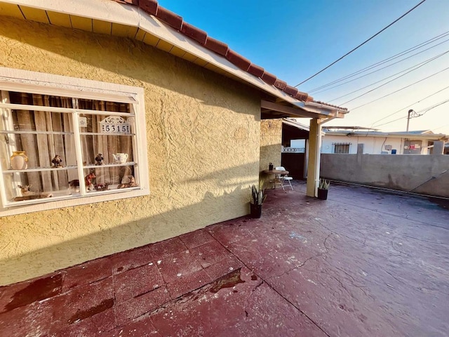 view of side of property featuring a patio