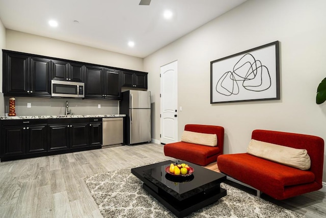 living room with sink and light wood-type flooring