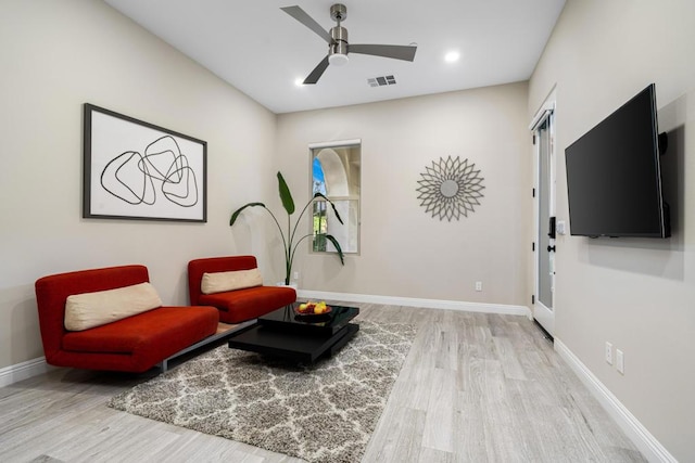 sitting room with light hardwood / wood-style flooring and ceiling fan