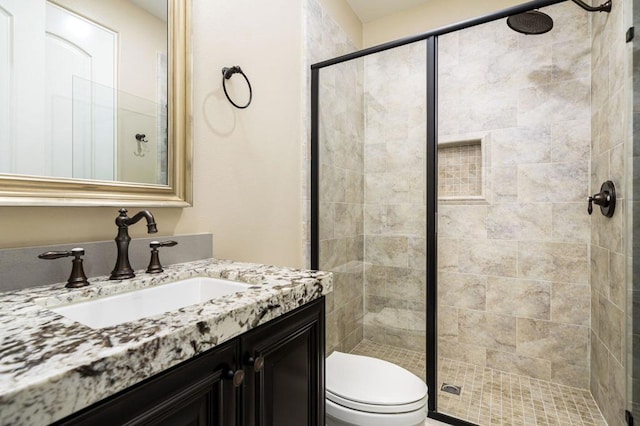 bathroom with vanity, toilet, and walk in shower