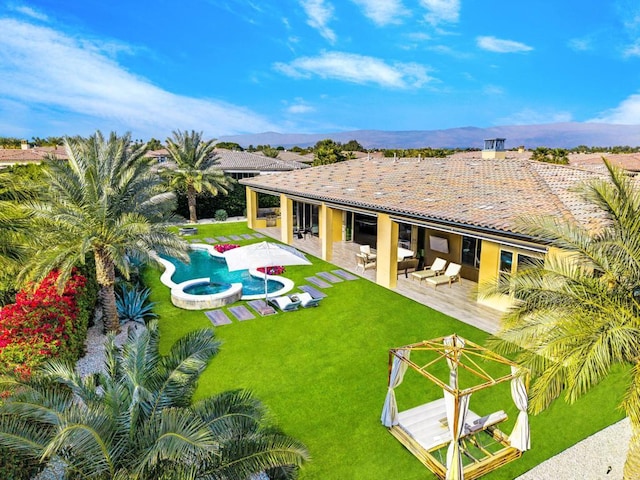 exterior space featuring an outdoor living space, a yard, a patio area, and an in ground hot tub