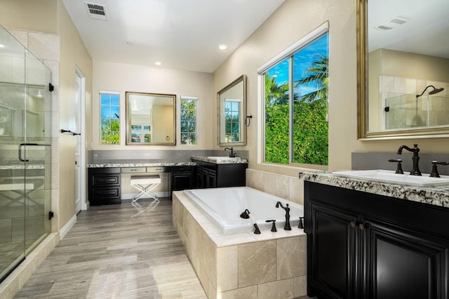 bathroom with vanity and separate shower and tub