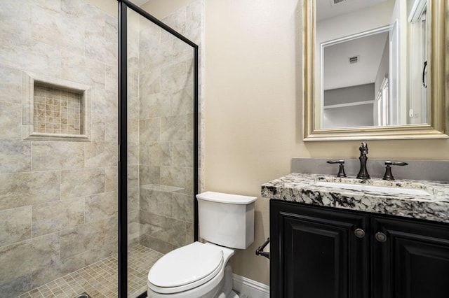 bathroom with vanity, walk in shower, and toilet