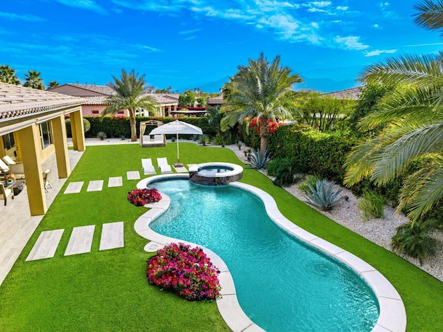 view of swimming pool featuring an in ground hot tub, a patio, and a lawn