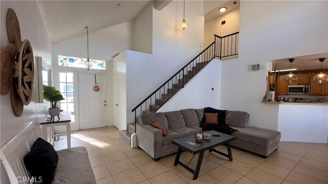 tiled living room with high vaulted ceiling