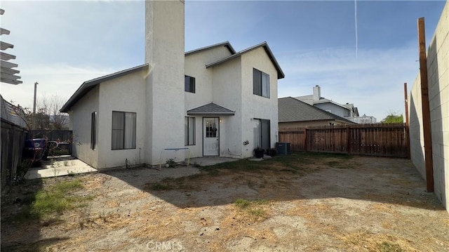 rear view of house with central air condition unit