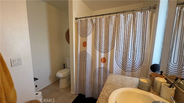 bathroom featuring vanity, a shower with shower curtain, tile patterned floors, and toilet