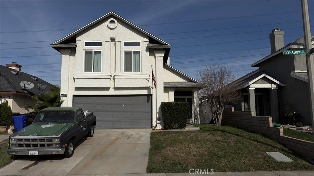 front of property featuring a garage and a front lawn