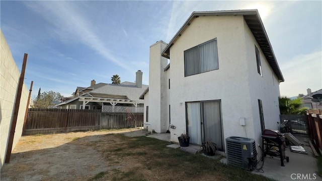 back of house featuring central AC