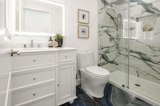 bathroom with vanity, toilet, and a shower with shower door