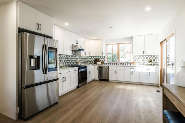 kitchen with appliances with stainless steel finishes and white cabinets