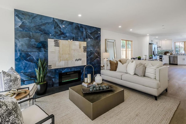 living room featuring hardwood / wood-style flooring and a premium fireplace