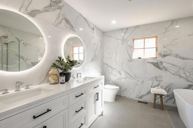 full bathroom featuring vanity, shower with separate bathtub, and toilet