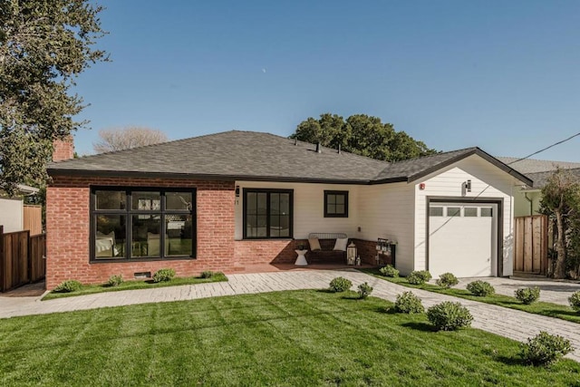 back of property with a garage and a yard