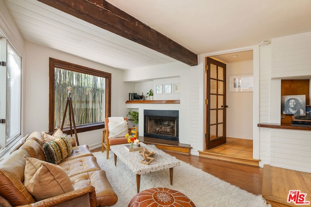 living room with beam ceiling and light hardwood / wood-style flooring