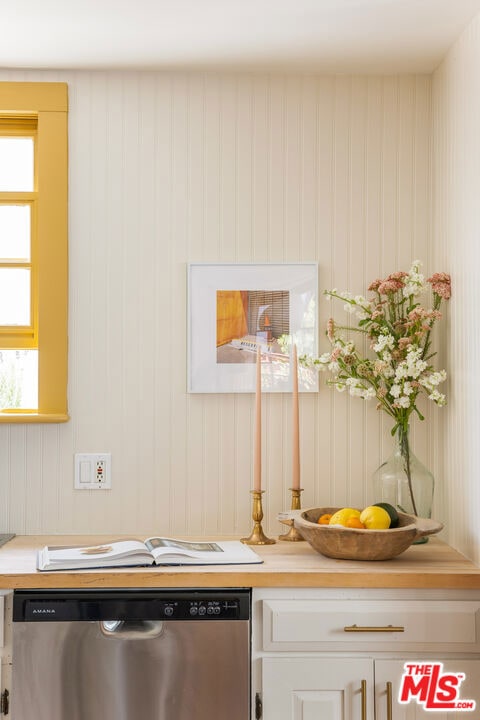 room details featuring white cabinetry and stainless steel dishwasher