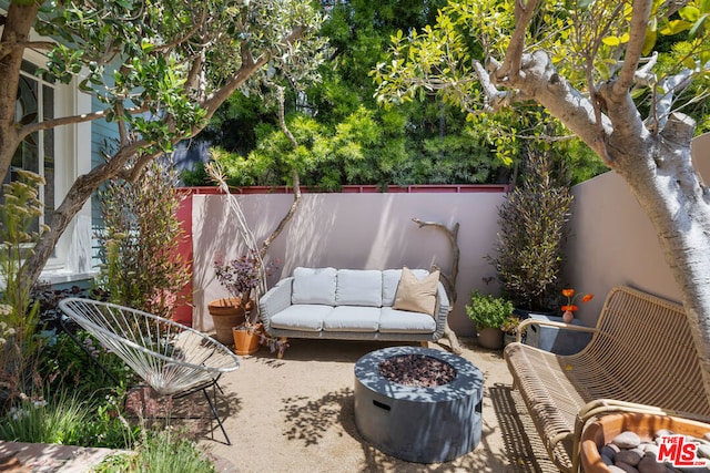 view of patio / terrace with an outdoor living space with a fire pit