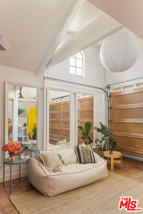 sunroom / solarium with lofted ceiling with beams