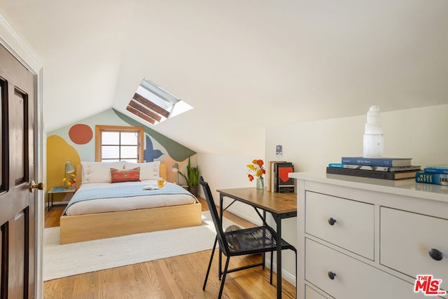 bedroom featuring light hardwood / wood-style flooring and vaulted ceiling