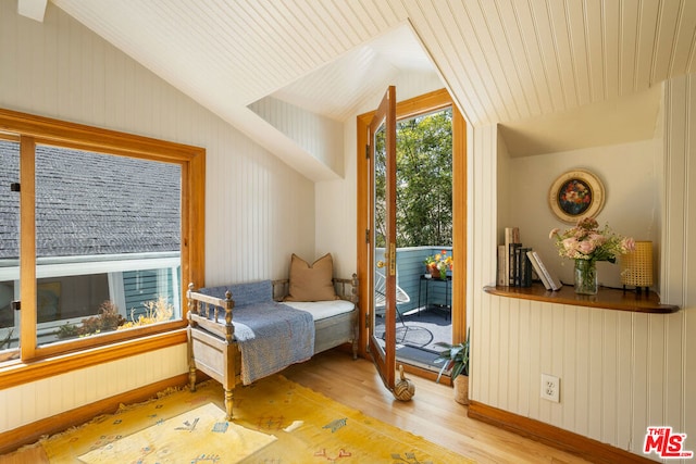 living area with vaulted ceiling and light hardwood / wood-style floors