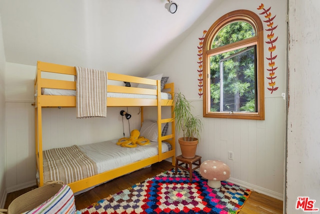 bedroom featuring hardwood / wood-style flooring and lofted ceiling