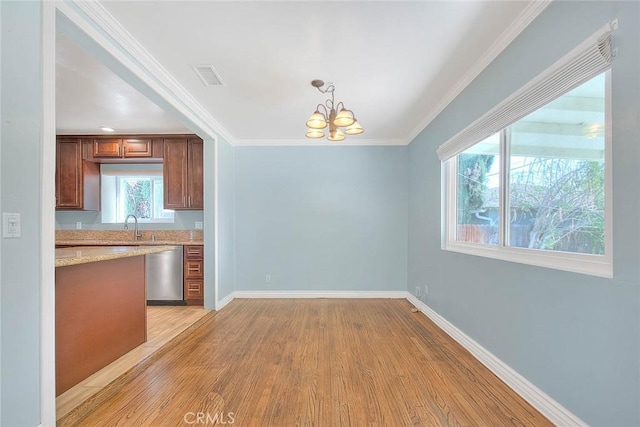 kitchen with light hardwood / wood-style flooring, a notable chandelier, light stone countertops, decorative light fixtures, and stainless steel dishwasher