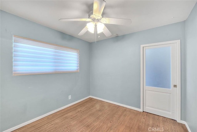 empty room with light hardwood / wood-style flooring and ceiling fan