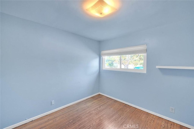 empty room with hardwood / wood-style floors