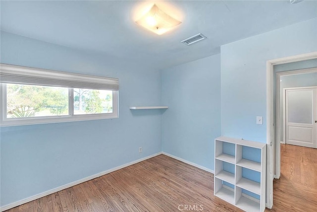 spare room featuring light wood-type flooring