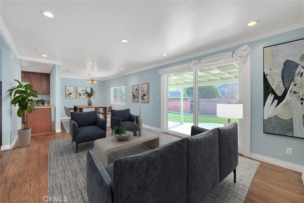 living room with light hardwood / wood-style flooring and ornamental molding