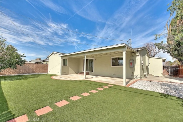 back of house featuring a yard and a patio