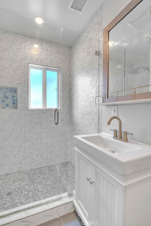 bathroom with vanity and an enclosed shower