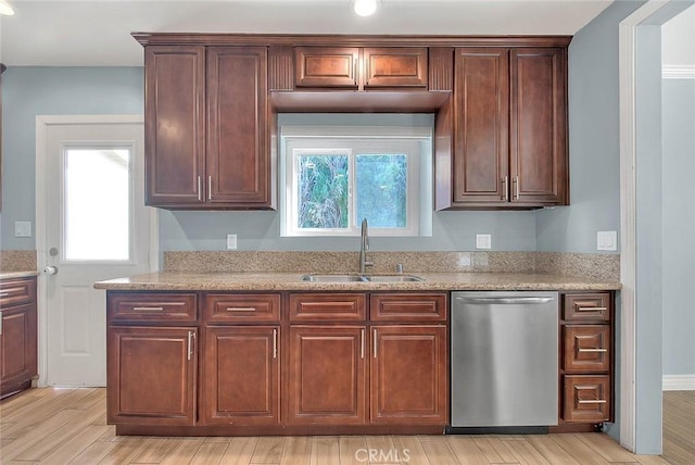 kitchen with dishwasher, plenty of natural light, sink, and light hardwood / wood-style floors