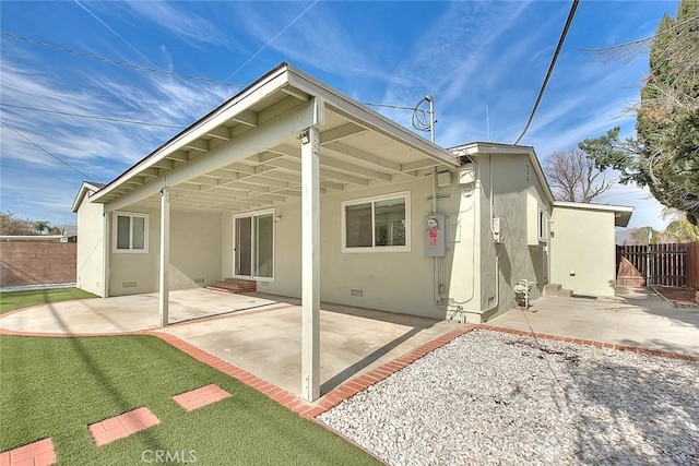 rear view of property with a patio area and a lawn